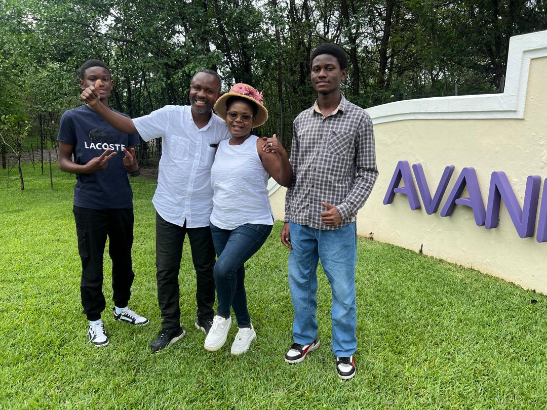 Mrs Mulwanda and her family outside Avani Victoria Falls Resort